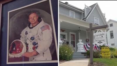 On the left, a framed photo of Neil Armstrong; on the right, a house for sale.