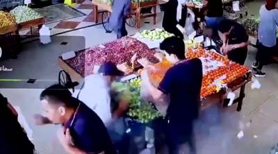 People in a supermarket react as a device explodes