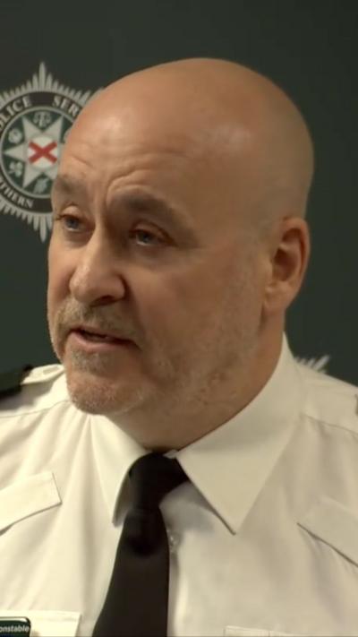 Assistant Chief Constable, Ryan Henderson, wearing white shirt and black tie