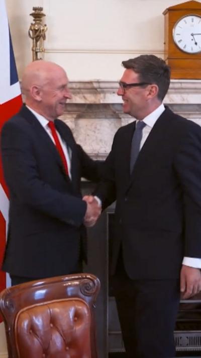 John Healey (left) and Andy Burnham shake hands
