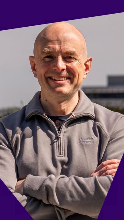 BBC's Gareth Lewis smiles to the camera from a rooftop garden on a sunny day.