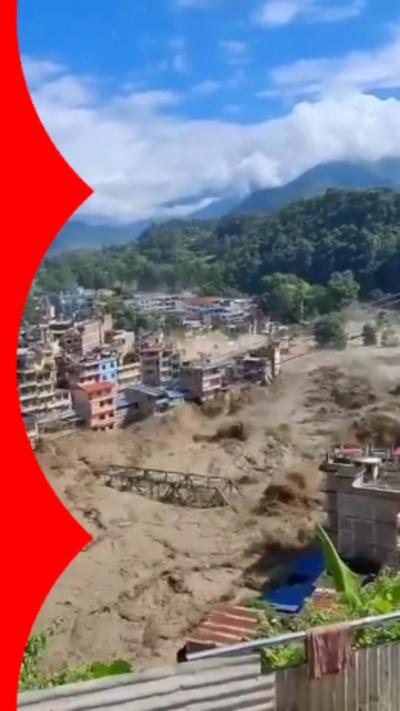 Muddy floodwaters take bridge down