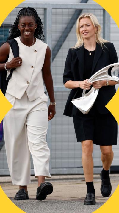 England players Michelle Agyemang and Leah Williamson walking out of the plane - Williamson is holding Euro trophy