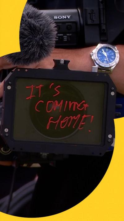 Arthur Fery write's 'It's coming home' on the camera ahead of England's World Cup match
