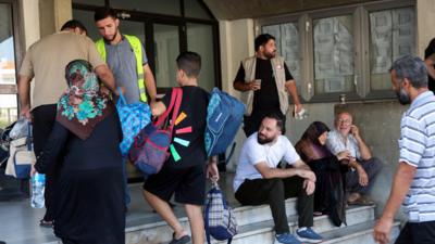 Internally displaced people, who fled from their southern Lebanon villages due to ongoing cross-border hostilities between Hezbollah and Israeli forces, arrive to take shelter at the Technical Institute of Bir Hassan, in Beirut 