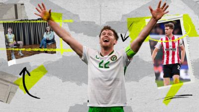 Nathan Collins celebrating success for Ireland with his arms in the air 