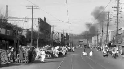 Refugees flee under British army supervision, while UN forces blow up bridges behind them as they retreat south.