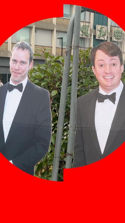 Cardboard cutouts of Robert Webb and David Mitchell with a tower block behind them, where the sitcom Peep Show was partially filmed