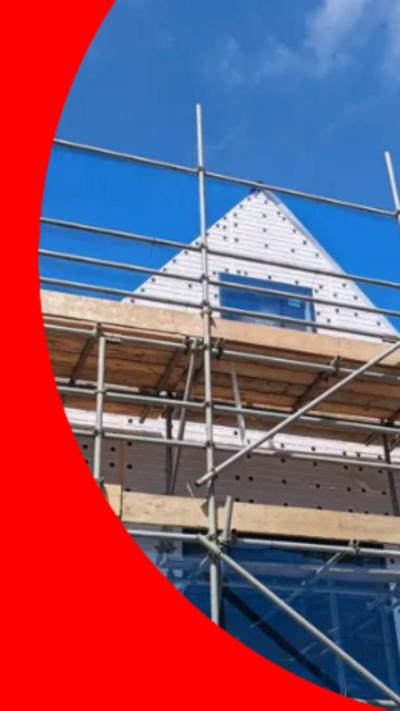 Image of a house surrounded by scaffolding.