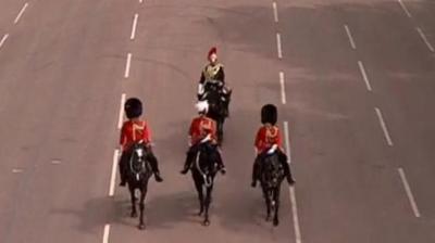 Three solders on horseback take part in the VE Day military parade