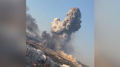 A large plume of smoke rises to the sky