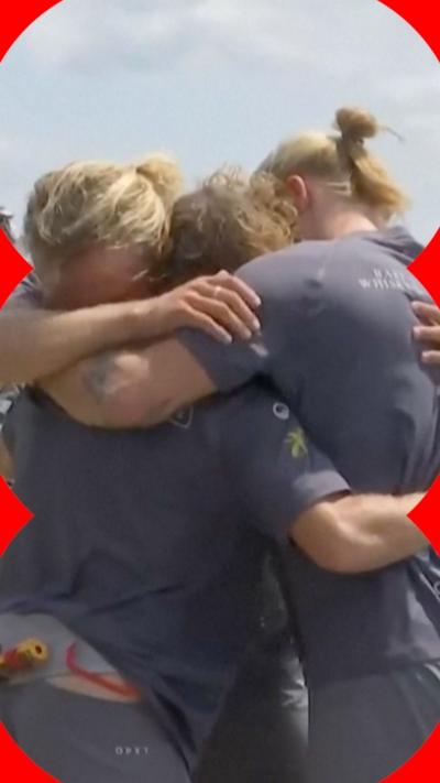 Three brothers embrace after rowing 9,000 miles
