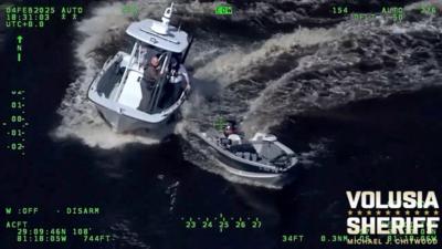 A sheriff's boat chases a smaller, out of control fishing boat. 