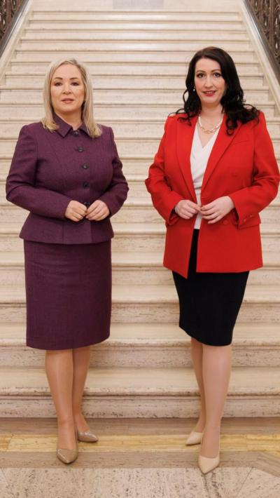 Michelle O'Neill and Emma Little-Pengelly stand at the bottom of a white marble staircase in Stormont.