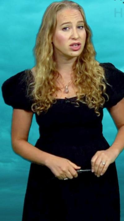 Sophia Herod standing in front of an image of Uranus