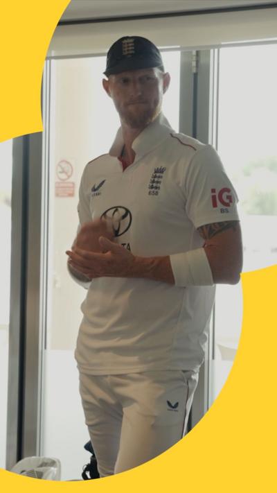 Ben Stokes wearing a white cricket uniform and a cap