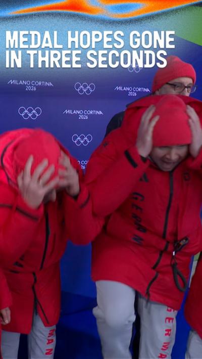 German coaches hang their heads as they watch on at the luge event