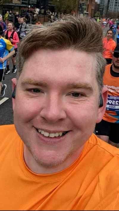 A man in an orange t-shirt running