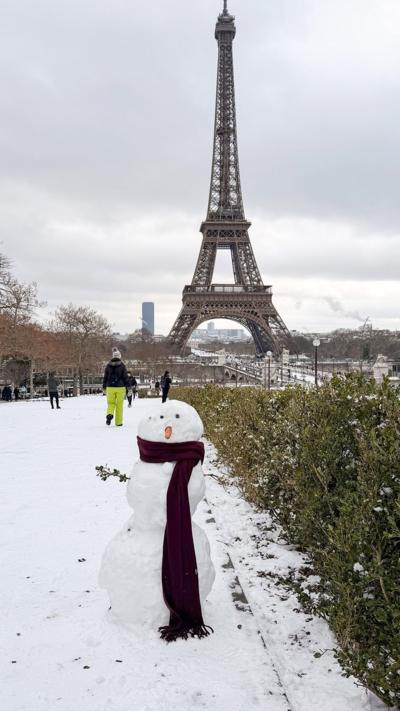 A snowman in front of the Eiffel Tower
