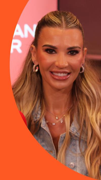 Christine McGuinness has long blonde hair and wears a denim shirt and silver hoop earrings 