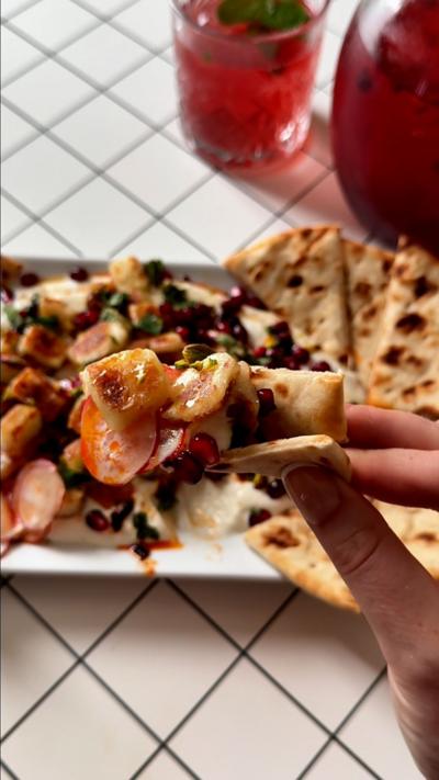 The dip loaded up onto a portion of flat bread.