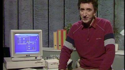 Presenter next to a Commodore Amiga.