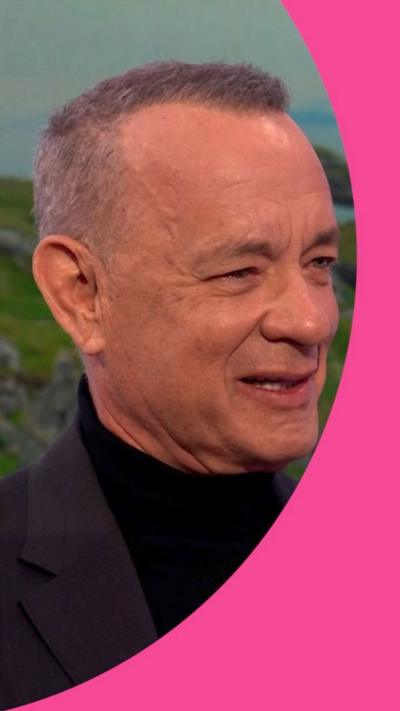Tom Hanks wearing a black top.