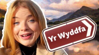 Megan Davies with road sign saying Yr Wyddfa