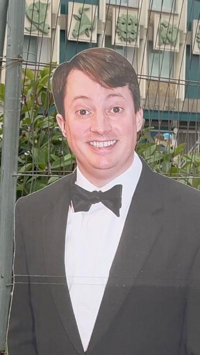 Cardboard cutout of David Mitchell with a tower block behind them where the sitcom Peep Show which the two actors are known for was partially filmed.