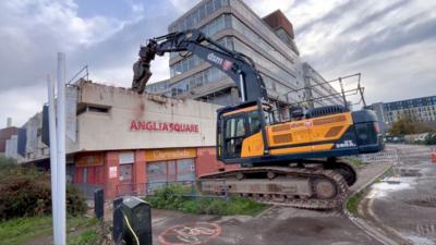 Heavy machinery demolishes a wall at the derelict Anglia Square shopping precinct in Norwich