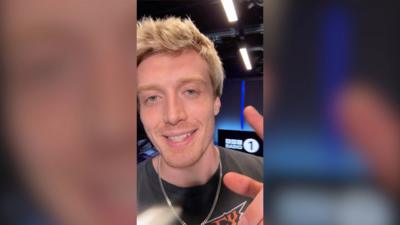 Radio 1 DJ Jack Saunders in the studio, smiling to the camera