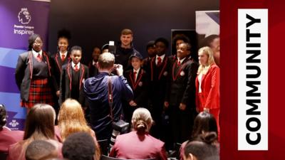 Timo Werner posers for a photo with local schoolkids at Tottenham