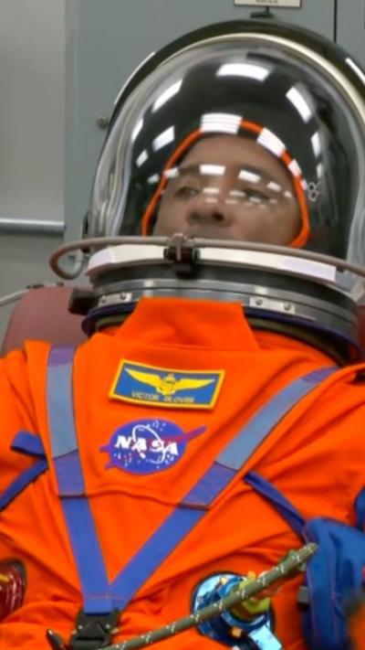 Astronaut in orange suit and helmet