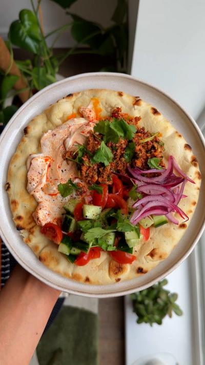Harissa sardine flatbreads on a white plate, with the photo taken from above
