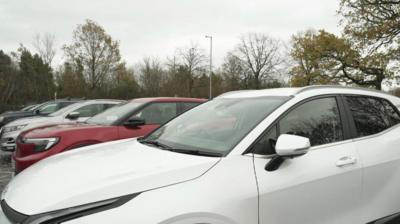 cars in a row while parked in a car park