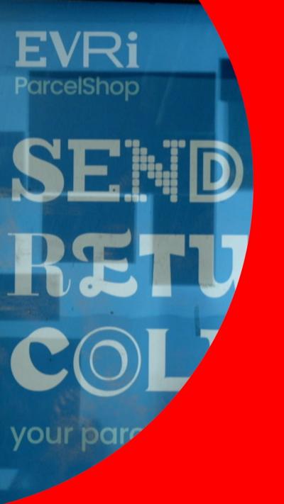 An advert for the Evri parcel delivery service on the side of a shop with the words 'Send Return Collect' underneath the logo