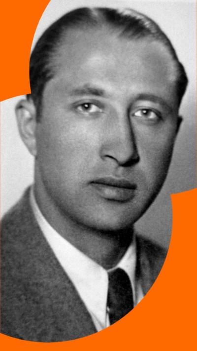 A black and white image of Duško Popov wearing a suite jacket over a white shirt and dark tie. He has short slicked-back hair.