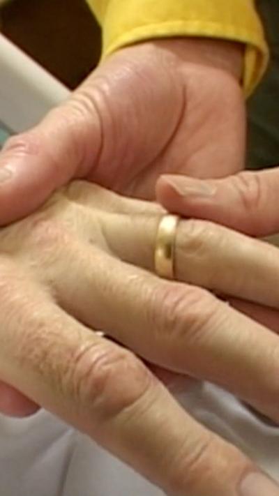 A ring being put on a finger.