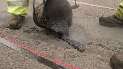 A pothole being repaired