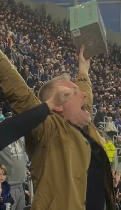 Man in football crowd with a toaster
