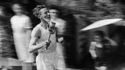 Man running with Olympic torch