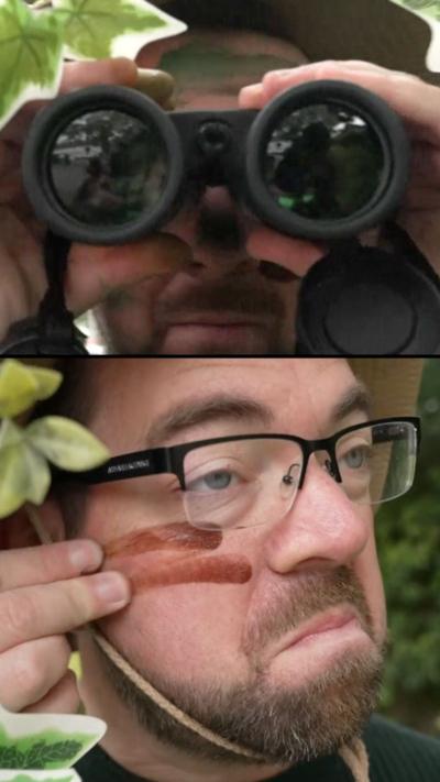Reporter Philip Norton in camouflage and with binoculars