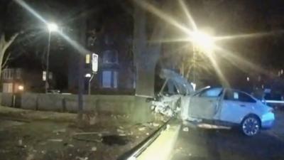 White BMW at night with a smash front end having hit a tree