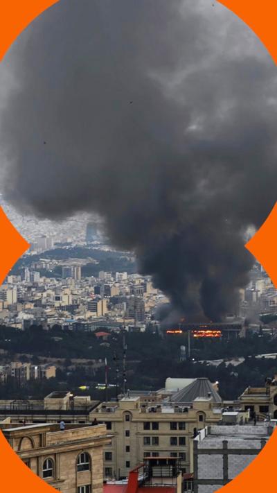 Black smoke billows out over buildings