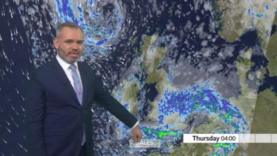 Ben Rich presenting weather forecast which shows large amounts of rain and gales over southern UK on Thursday morning