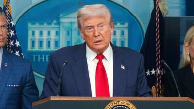 Donald Trump is talking to the press.