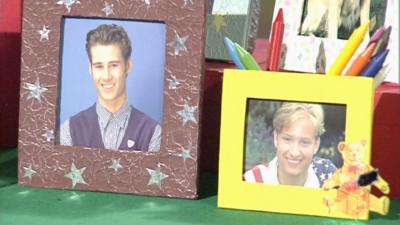 A brown picture frame with silver stars and a yellow picture frame with a bear on it