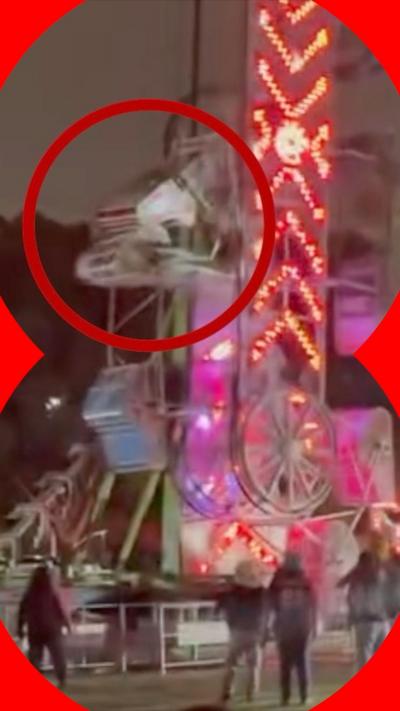 A cubicle on a fairground ride covered in neon lights in Los Angeles can be seen breaking off as people stand by and watch