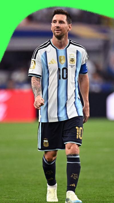 Lionel Messi walking across a pitch in full Argentina football kit