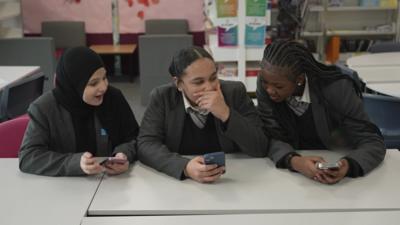 School children on their mobile phones